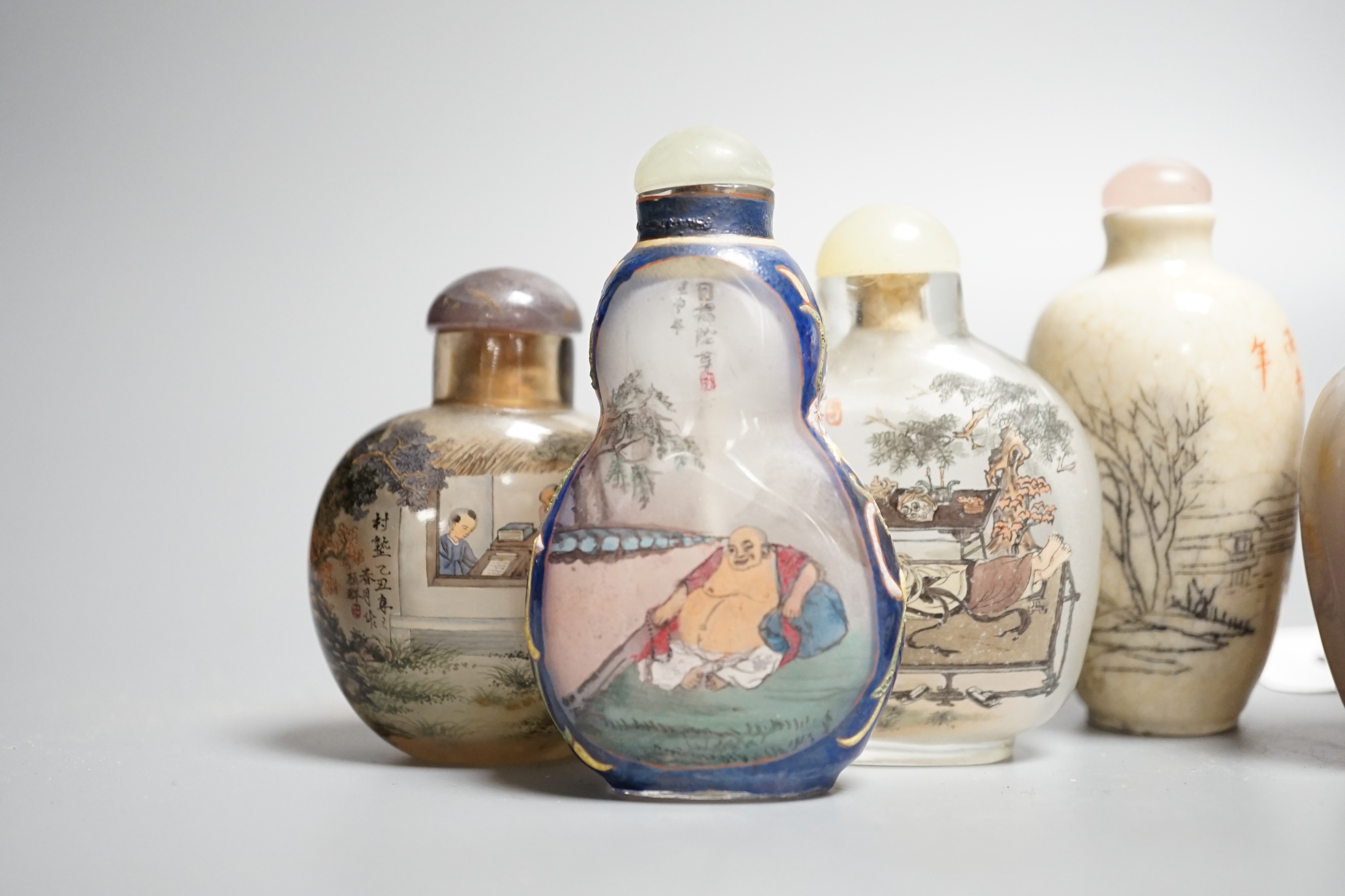 Six Chinese inside painted glass snuff bottles, an agate cameo snuff bottle and an incised crackle glaze snuff bottle, tallest 9cm